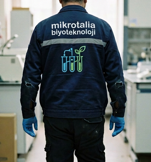 Biotechnology technician walking through a laboratory with equipment